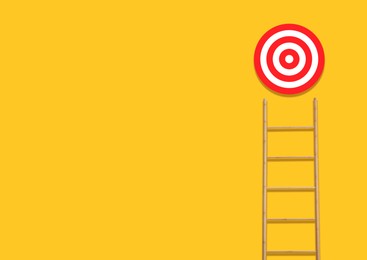 Image of Ladder leading to target on golden background, space for text. Concepts of success and goal achievement