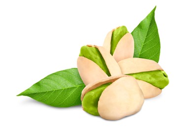 Unshelled pistachios and green leaves on white background. Tasty nut