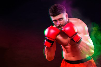 Image of Boxer training in smoke on black background, space for text. Glitch effect