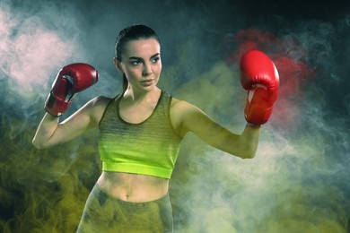 Image of Boxer fighting in color smoke under spotlights