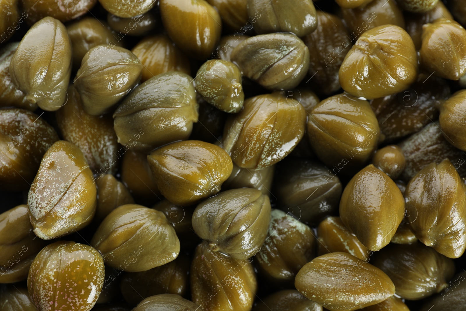 Photo of Closeup of pickled capers as background, top view