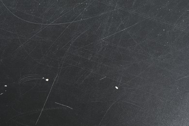 Photo of Texture of scratched black surface as background, closeup