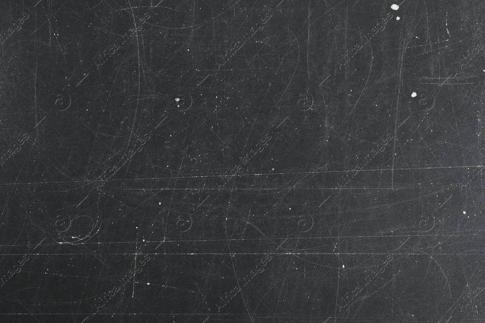 Photo of Texture of scratched black surface as background, closeup