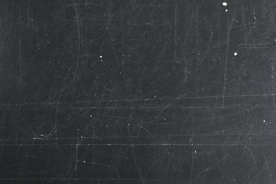 Photo of Texture of scratched black surface as background, closeup