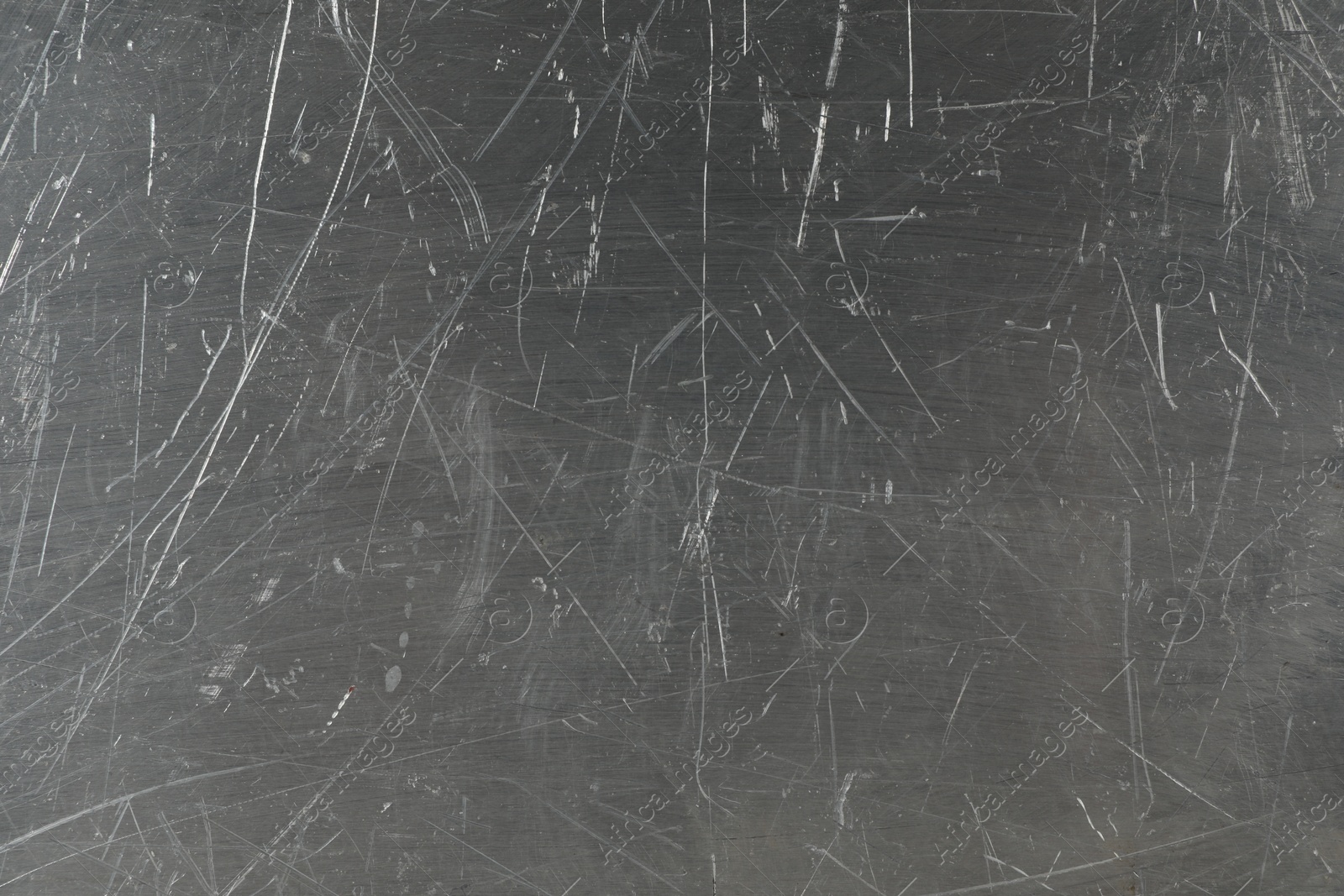 Photo of Texture of scratched metallic surface as background, closeup