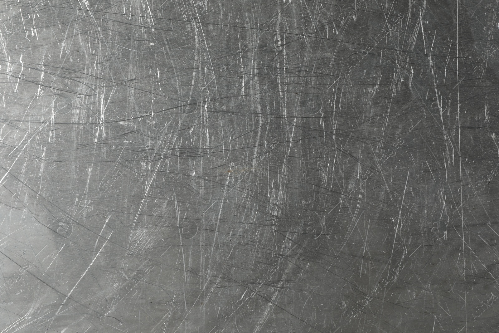 Photo of Texture of scratched metallic surface as background, closeup