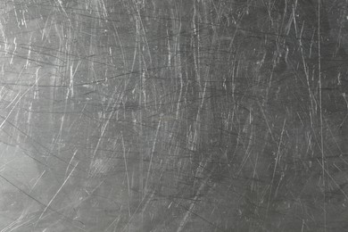 Photo of Texture of scratched metallic surface as background, closeup