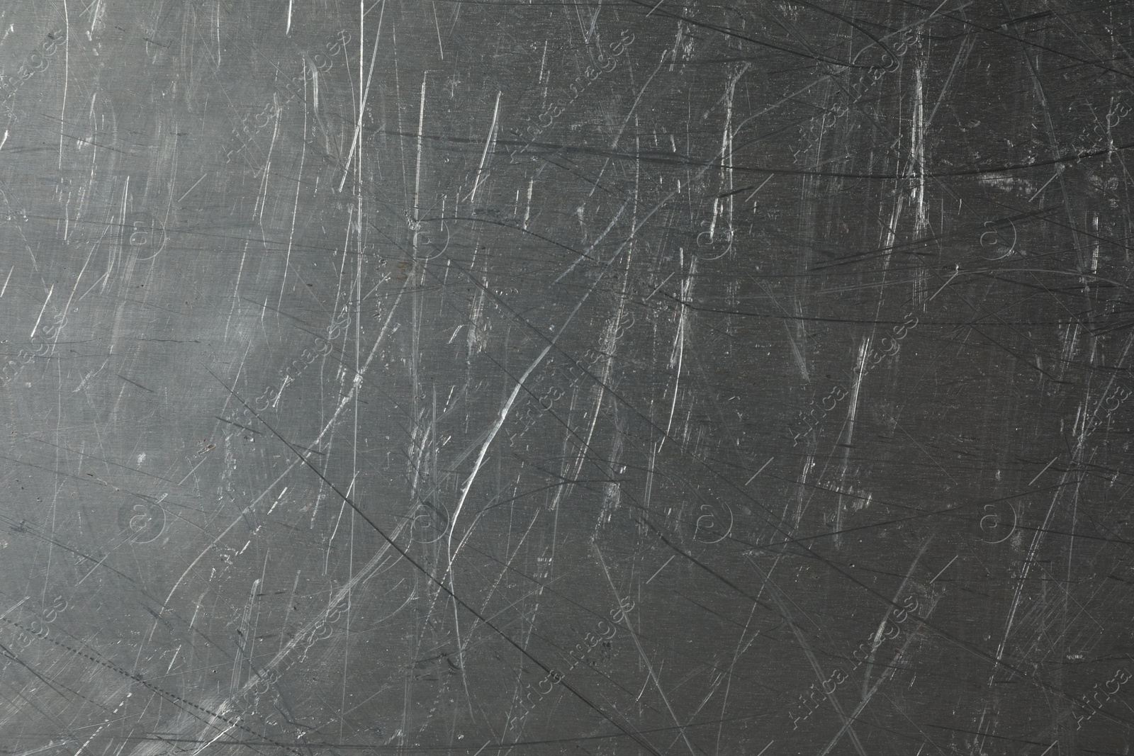 Photo of Texture of scratched metallic surface as background, closeup