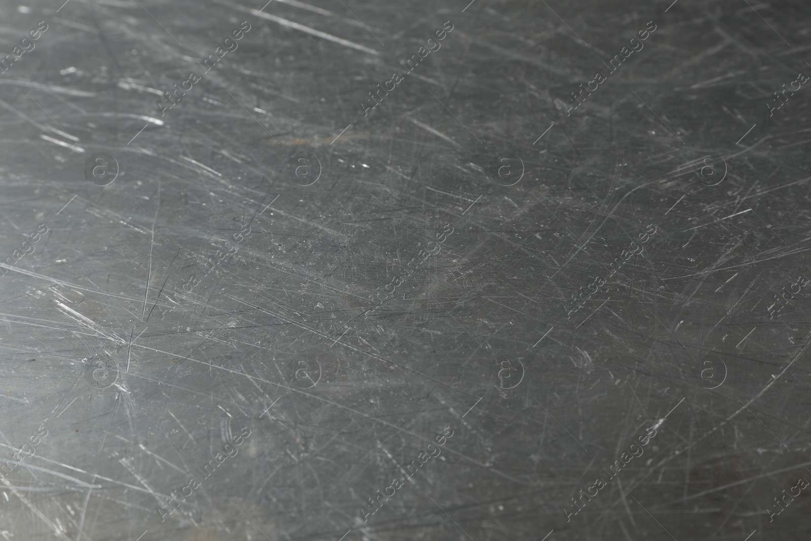 Photo of Texture of scratched metallic surface as background, closeup