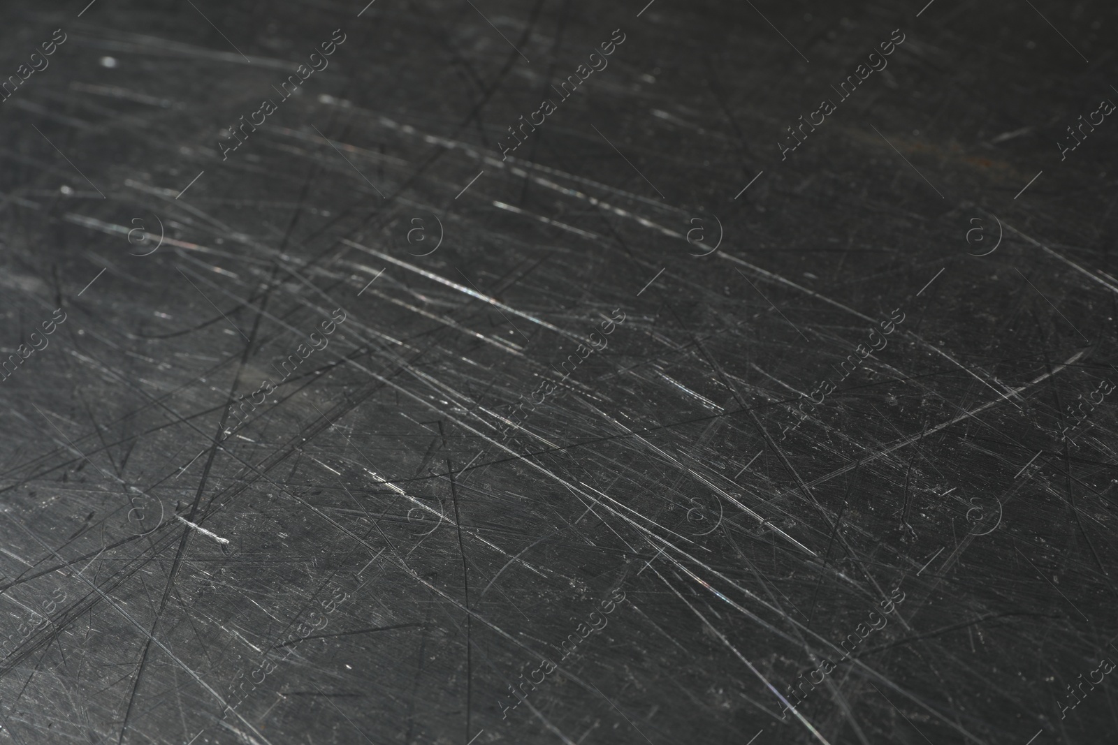 Photo of Texture of scratched metallic surface as background, closeup