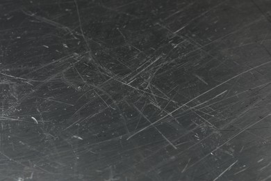 Photo of Texture of scratched metallic surface as background, closeup