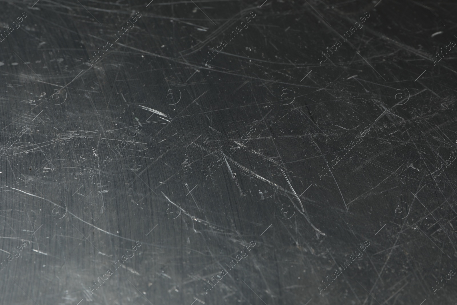 Photo of Texture of scratched metallic surface as background, closeup