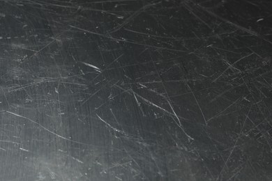 Photo of Texture of scratched metallic surface as background, closeup