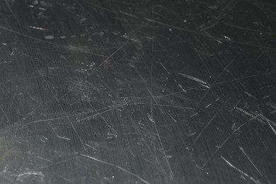 Texture of scratched metallic surface as background, closeup