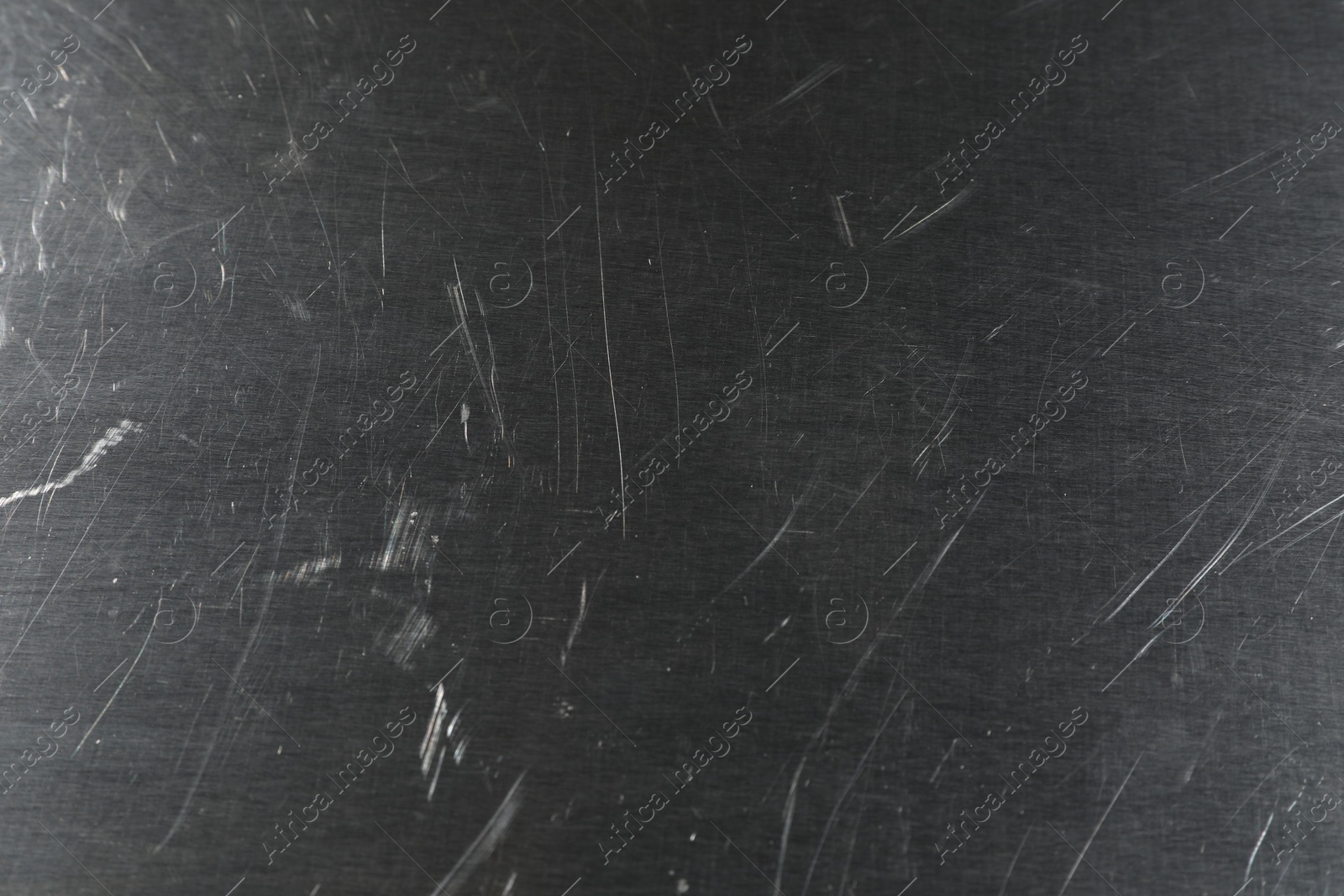 Photo of Old metal surface with scratches as background, closeup