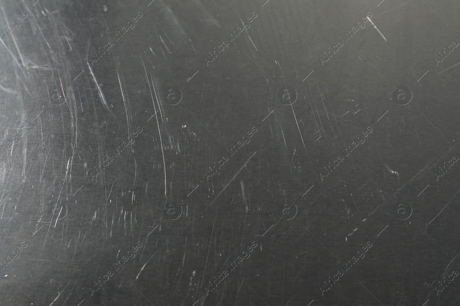 Photo of Old metal surface with scratches as background, closeup