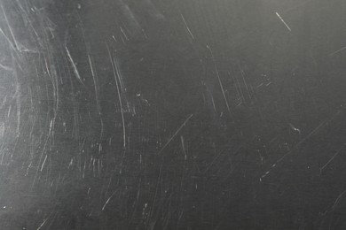 Photo of Old metal surface with scratches as background, closeup