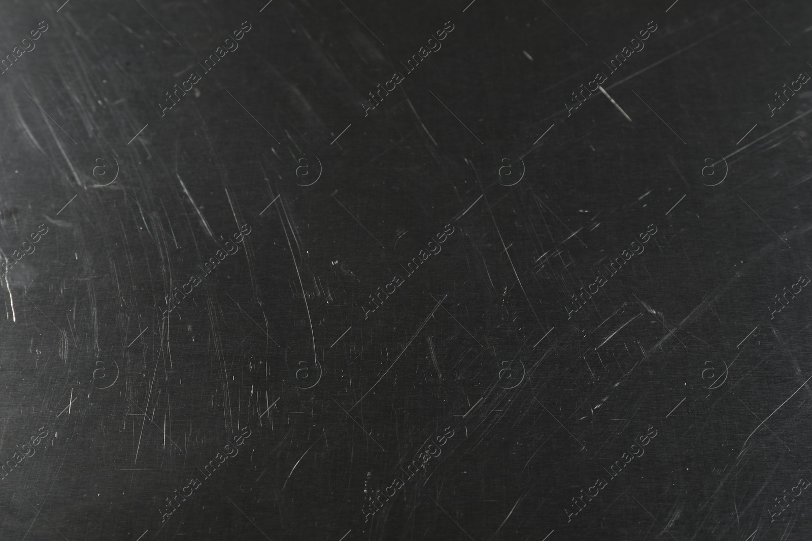 Photo of Old metal surface with scratches as background, closeup