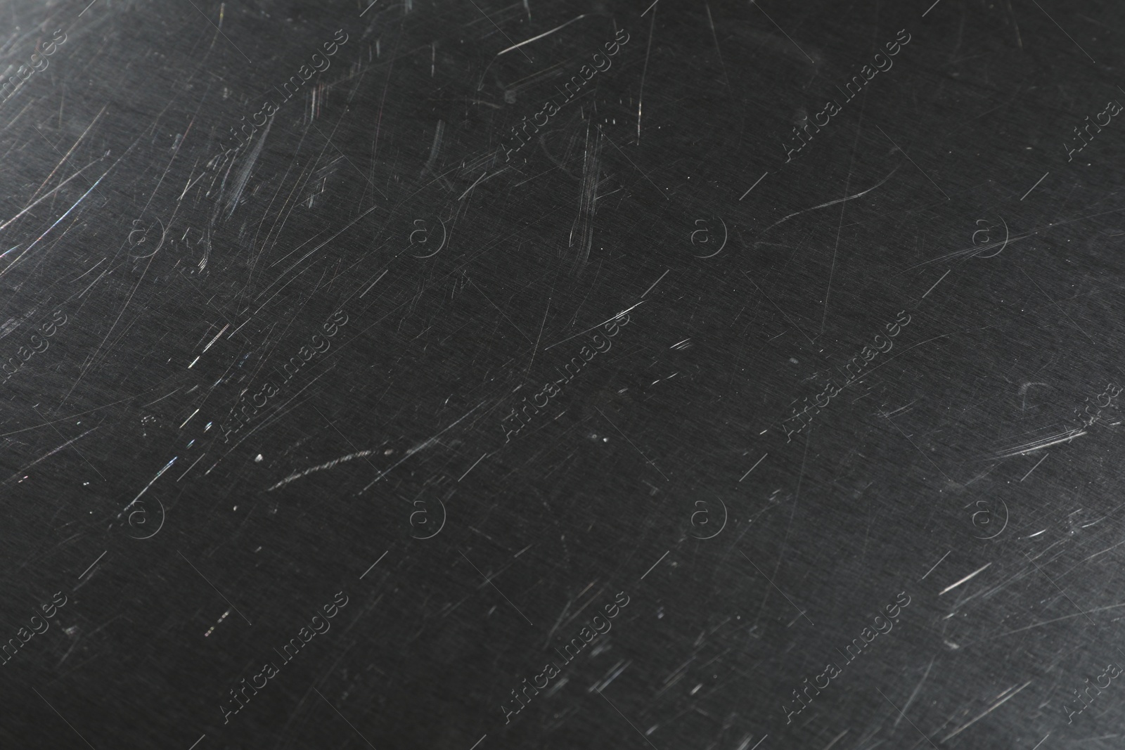 Photo of Old metal surface with scratches as background, closeup