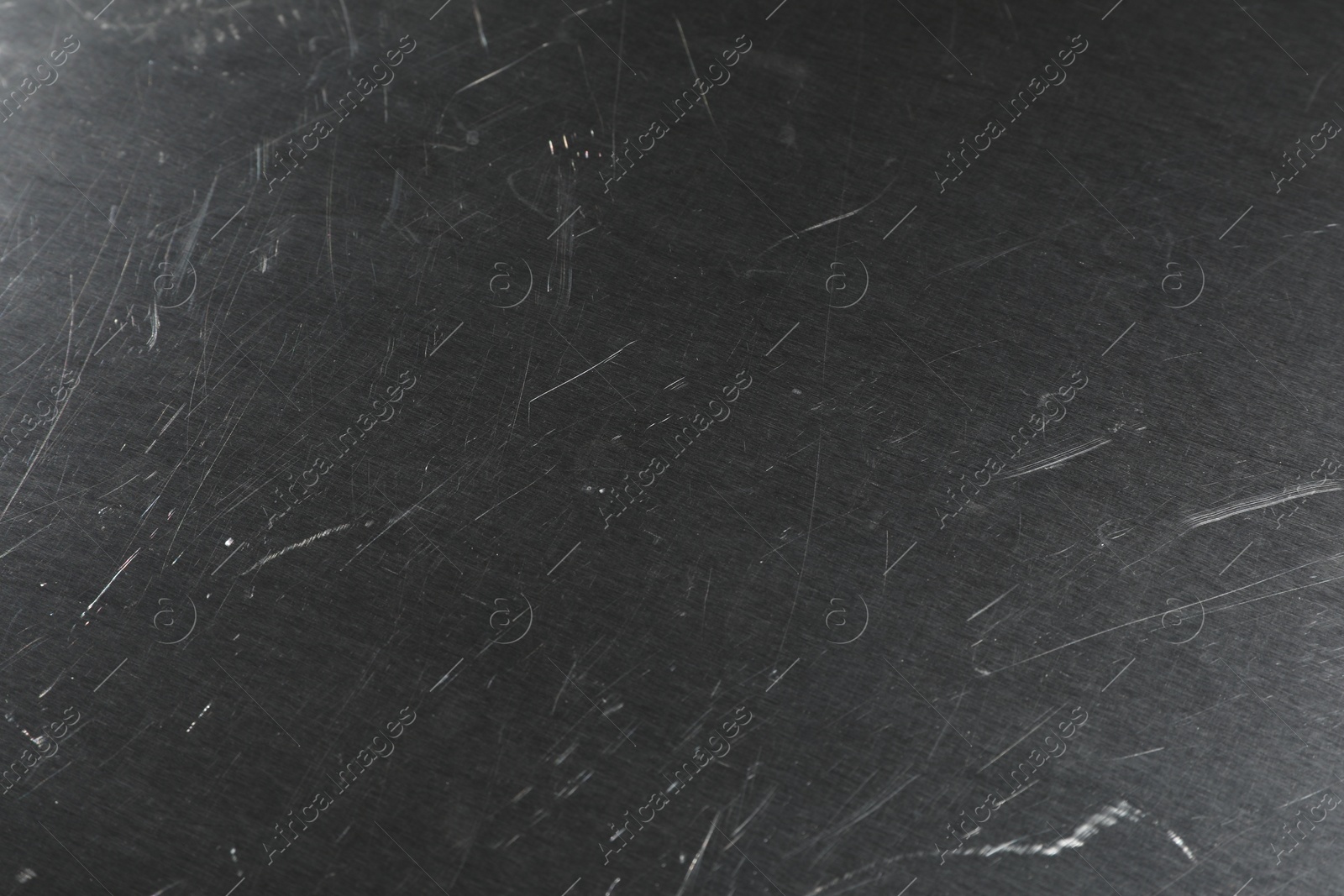 Photo of Old metal surface with scratches as background, closeup