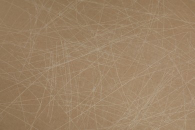 Photo of Old fiberboard with scratches as background, closeup