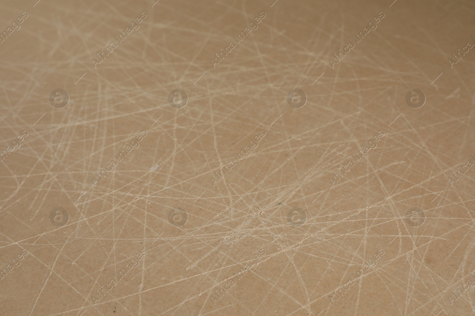 Photo of Old fiberboard with scratches as background, closeup