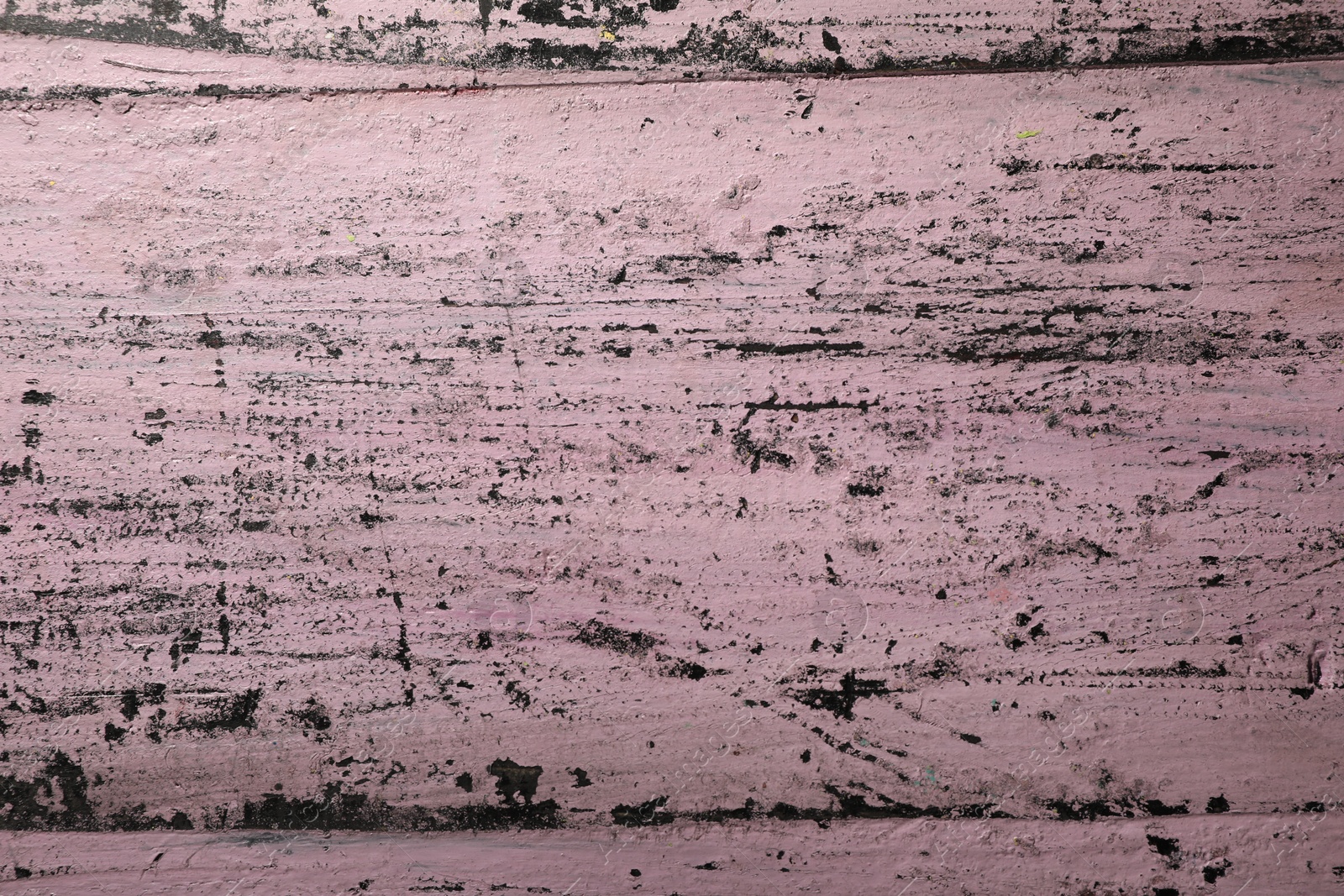 Photo of Old pink wooden surface with scratches as background, closeup