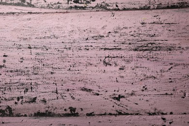 Photo of Old pink wooden surface with scratches as background, closeup