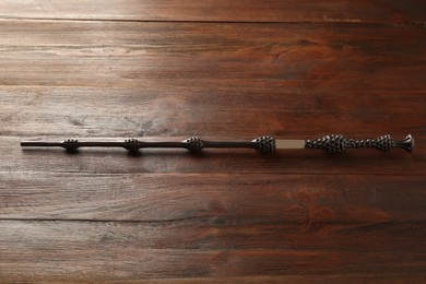 Photo of One old magic wand on wooden table