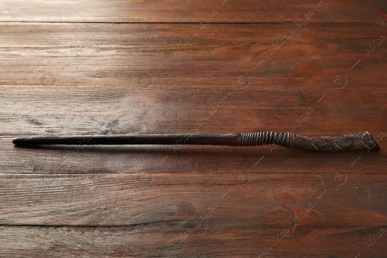 Photo of One old magic wand on wooden table