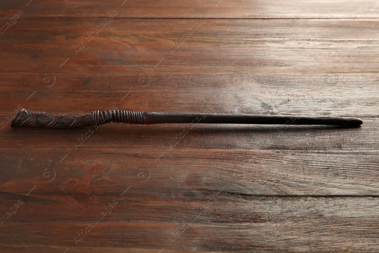 Photo of One old magic wand on wooden table