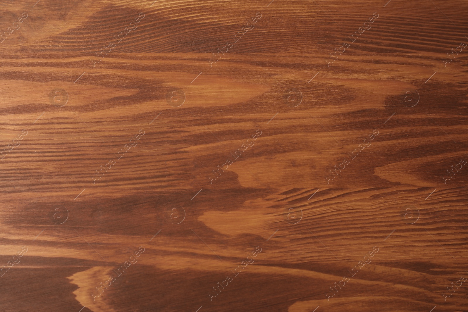 Photo of Applying walnut wood stain. Texture of wooden surface as background, top view