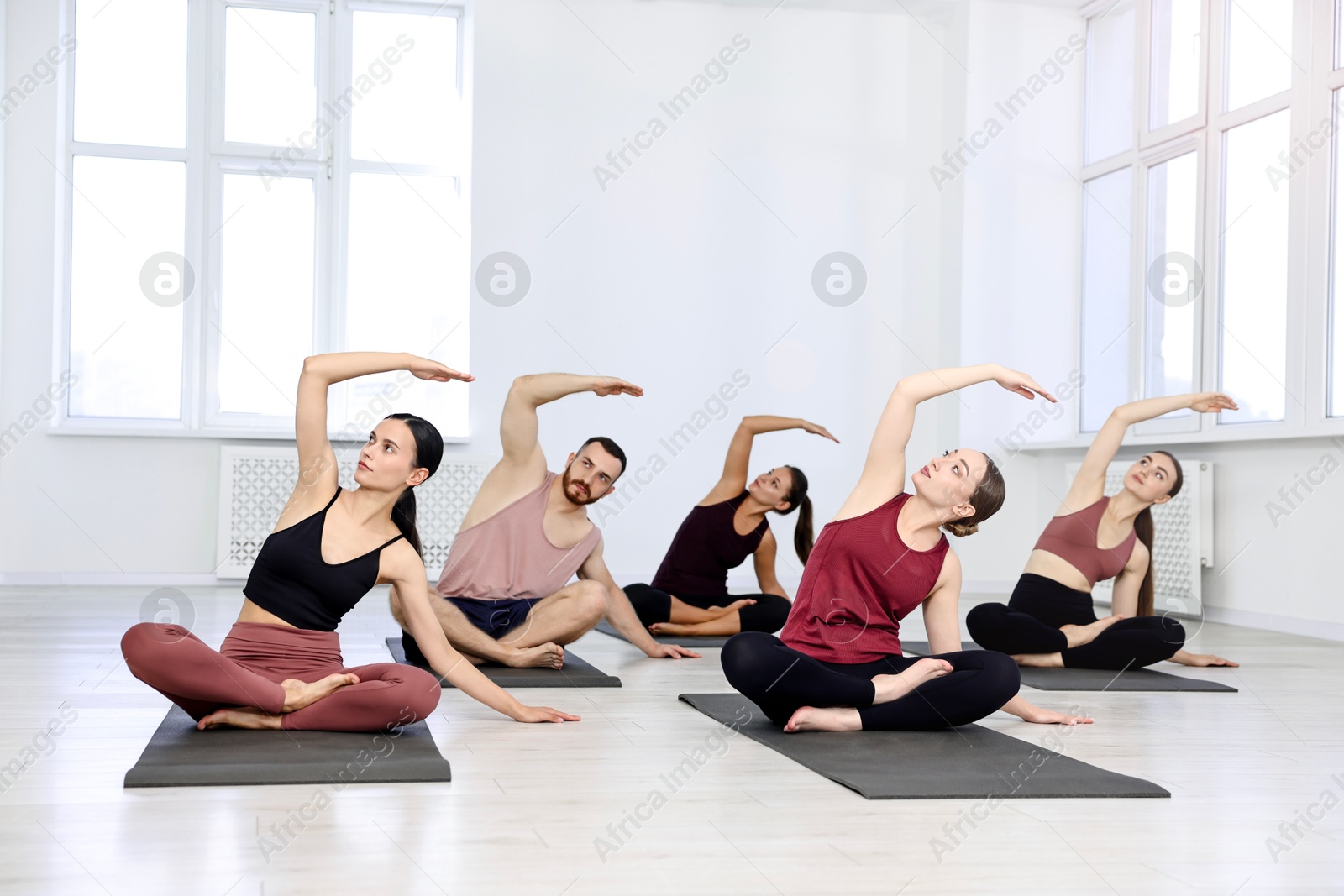 Photo of Group of people practicing yoga on mats in class