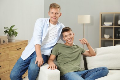 Photo of Happy brothers spending time together at home