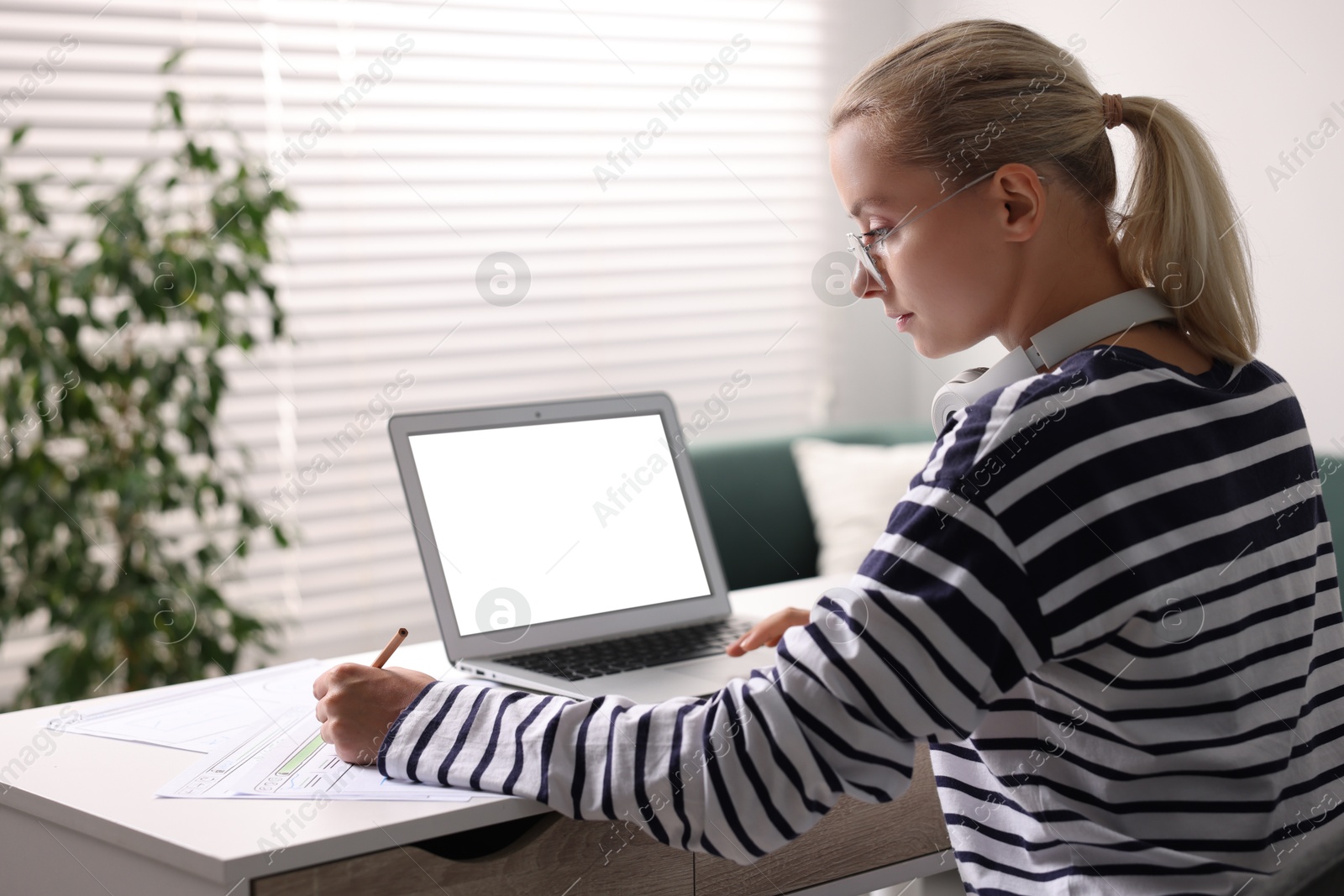 Photo of Woman working at table with laptop in office