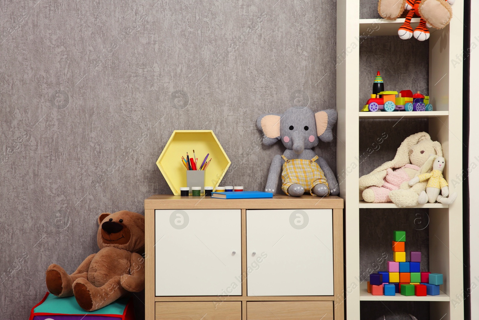 Photo of Beautiful kid's room interior with toys and stylish furniture