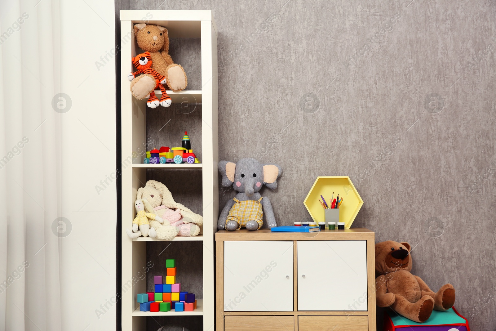 Photo of Beautiful kid's room interior with toys and stylish furniture