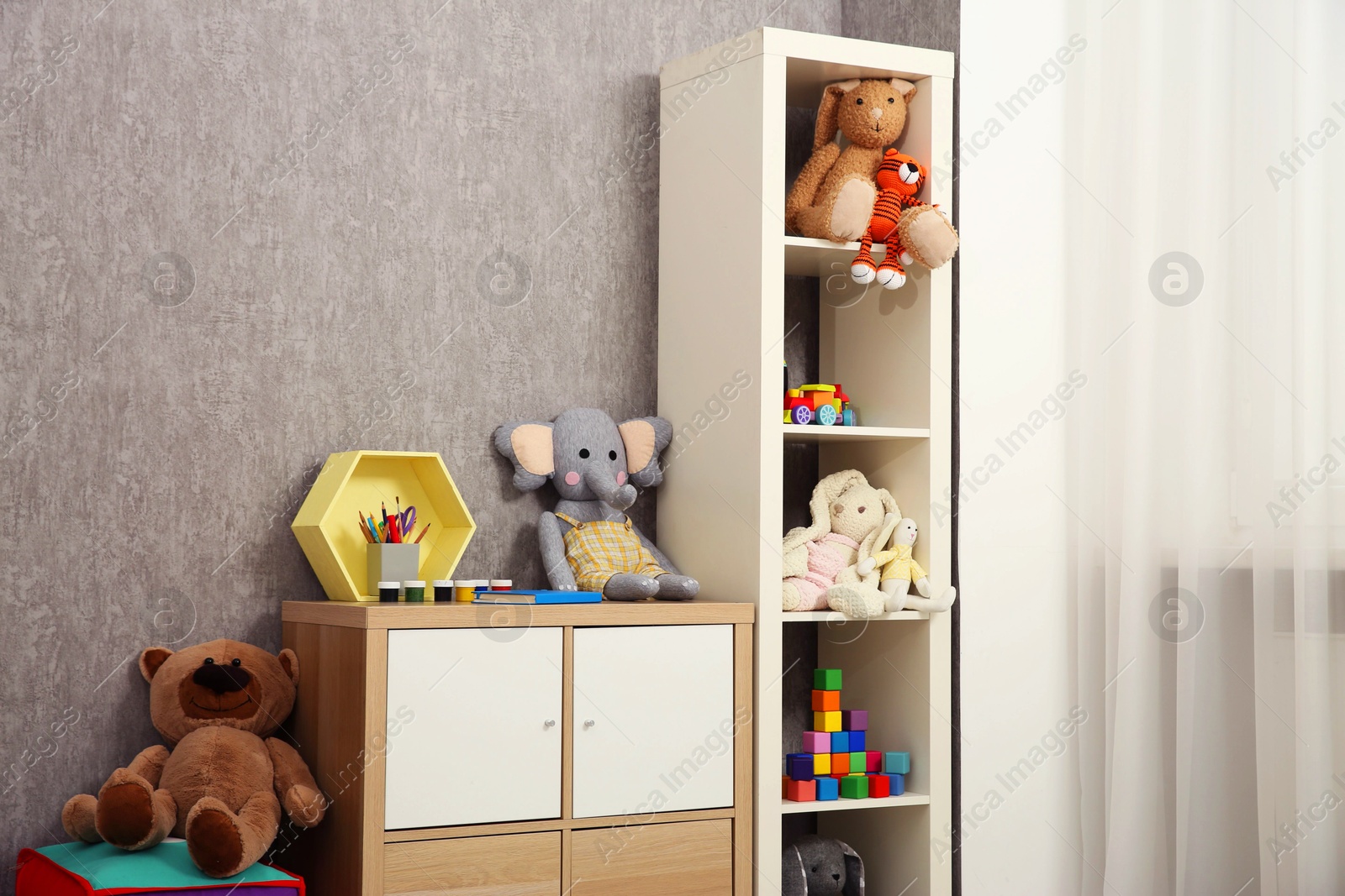 Photo of Beautiful kid's room interior with toys and stylish furniture