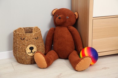 Photo of Teddy bear, ball and basket in kid's room