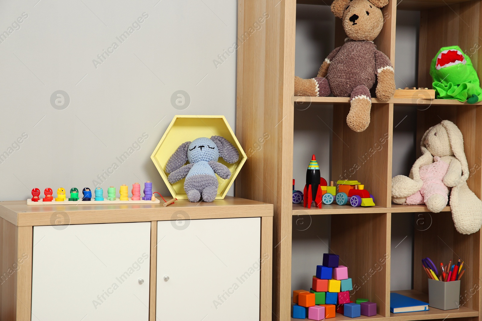 Photo of Beautiful kid's room interior with toys and stylish furniture