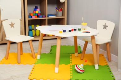 Photo of Beautiful kid's room interior with toys and stylish furniture