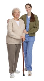 Caregiver supporting senior woman with walking cane on white background. Home health care service