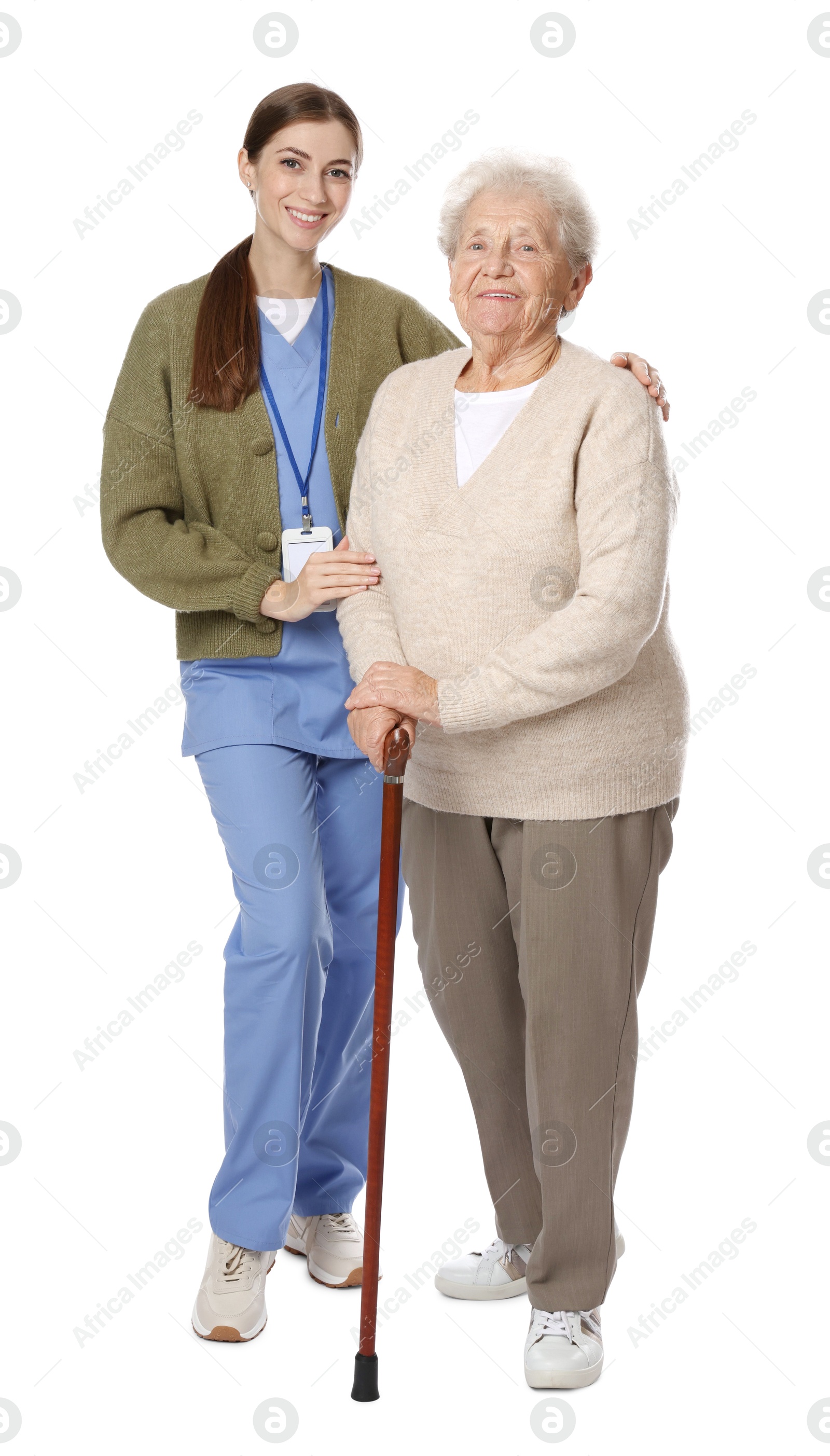 Photo of Caregiver supporting senior woman with walking cane on white background. Home health care service