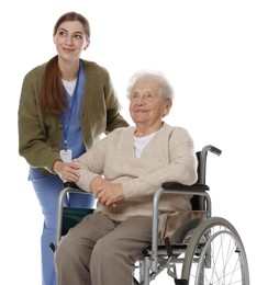 Caregiver assisting senior woman in wheelchair on white background. Home health care service