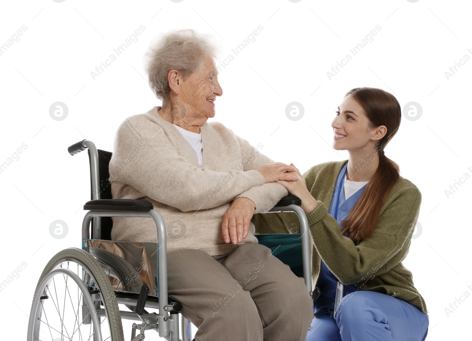 Photo of Caregiver assisting senior woman in wheelchair on white background. Home health care service