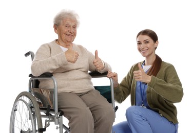 Caregiver and senior woman showing thumbs up on white background. Home health care service