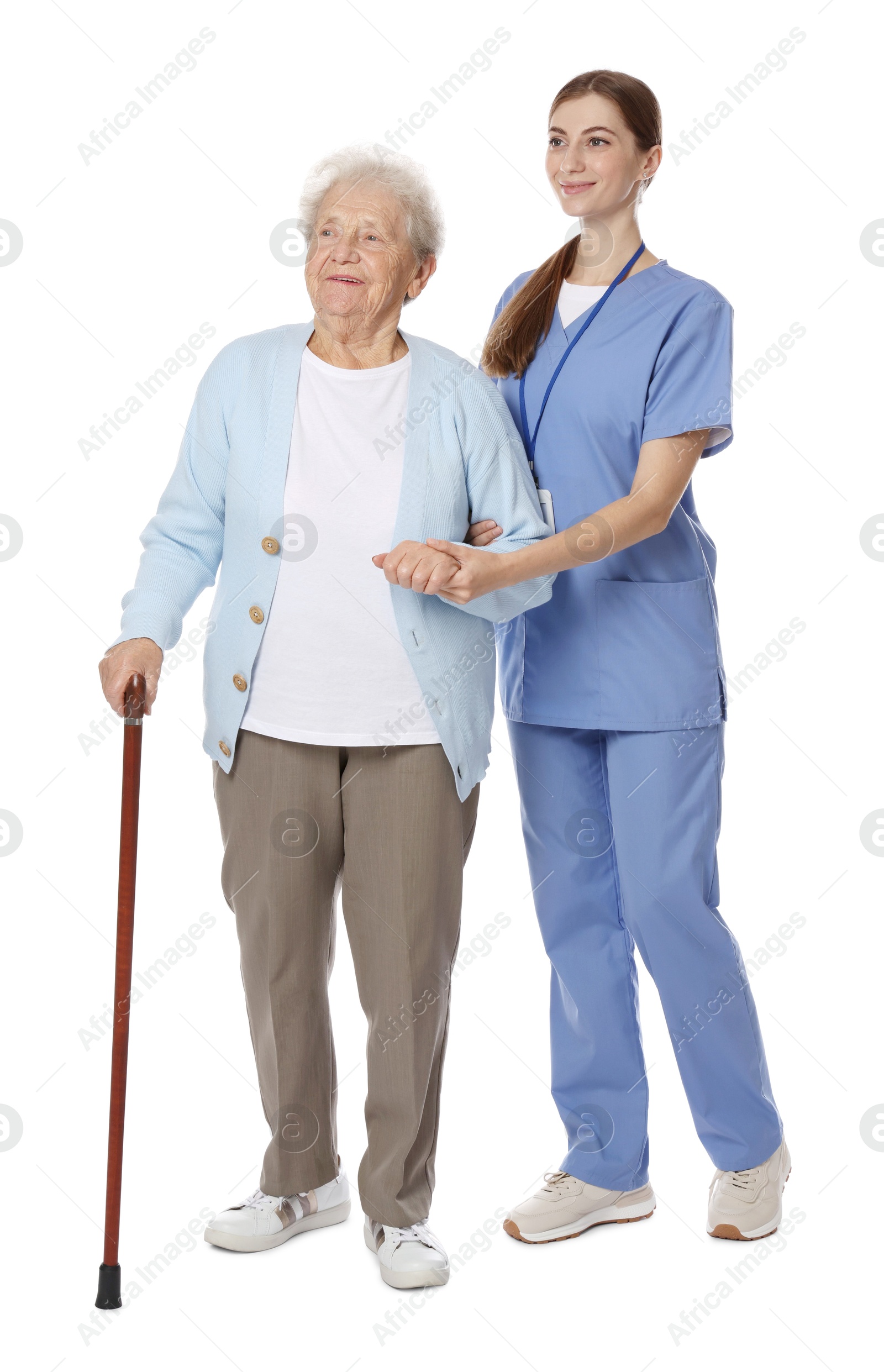 Photo of Caregiver supporting senior woman with walking cane on white background. Home health care service