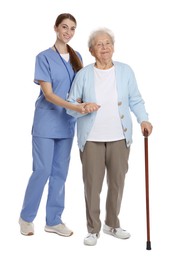 Caregiver supporting senior woman with walking cane on white background. Home health care service