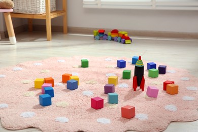 Photo of Colorful cubes and rocket toy in child's room