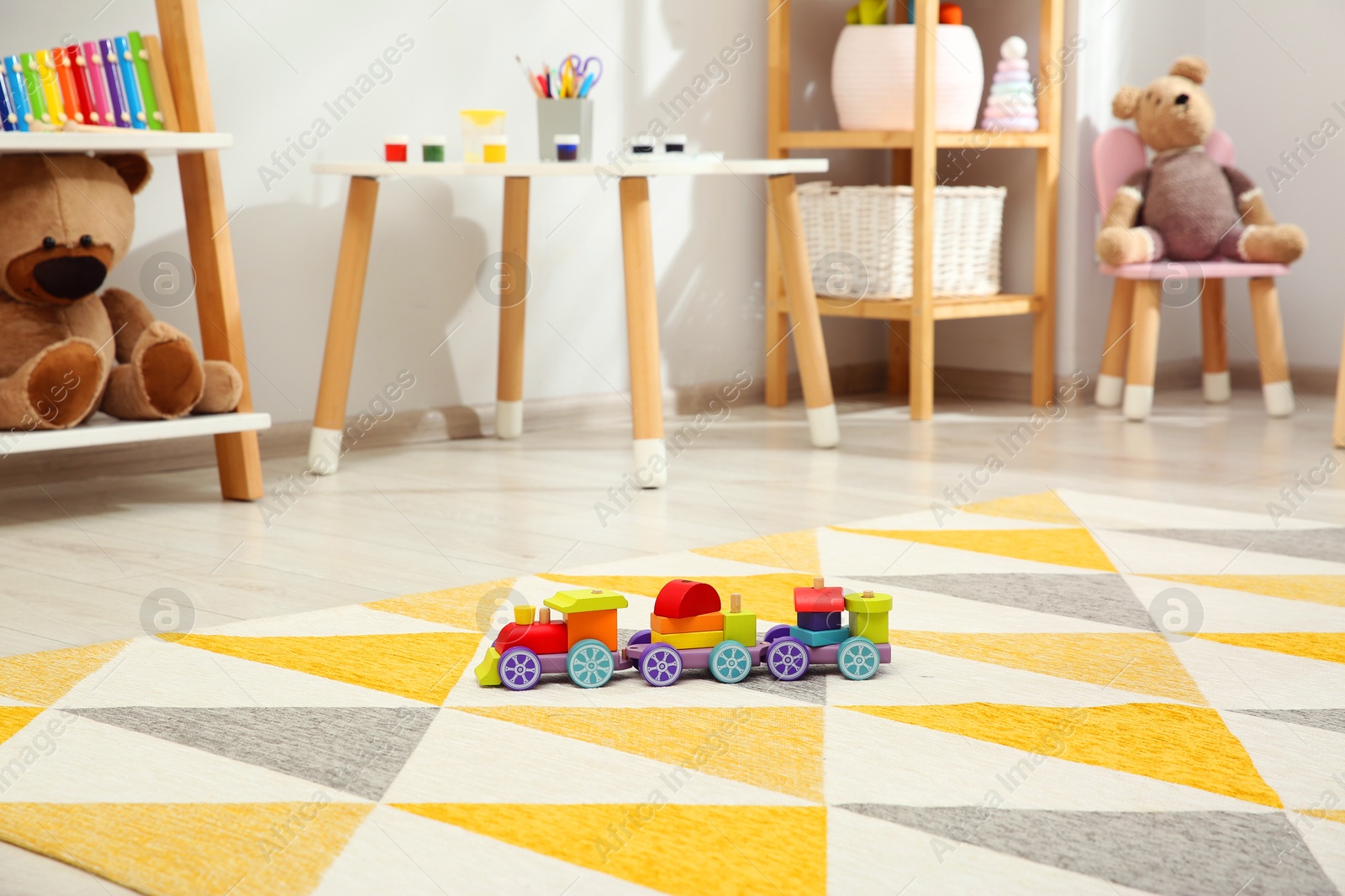 Photo of Colorful train and other toys in child's room